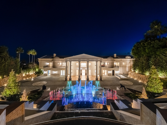 Illuminated arrival court and grand entrance at night